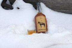 E.M. Walton's Corn Whiskey in the snow